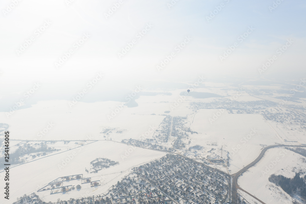 Balloon on the background of a winter landscape, view from a height