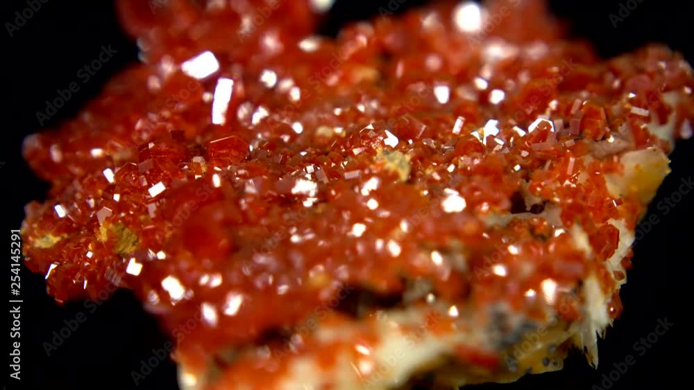 Seamlessly rotating a blood orange mineral (Vanadinite Crystal) in front of black background Seamlessly rotating a blood orange mineral (Vanadinite Crystal) in front of black background