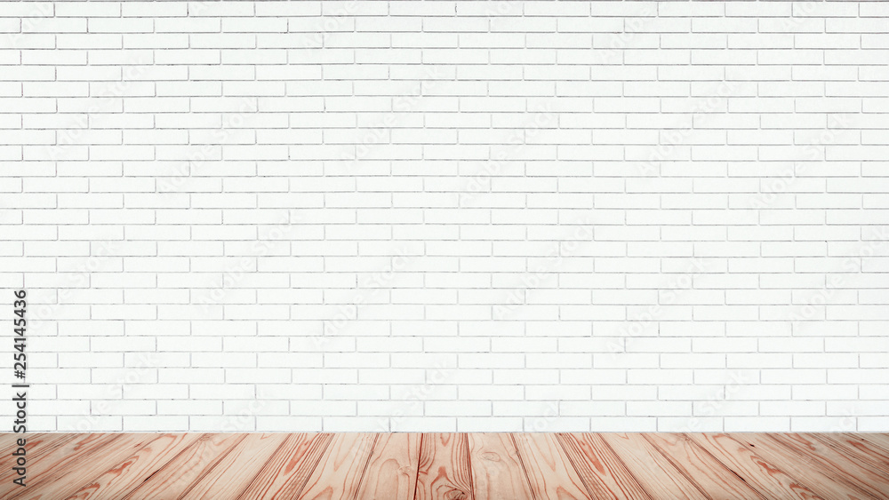 Empty top of wood floor with white brick wall background.