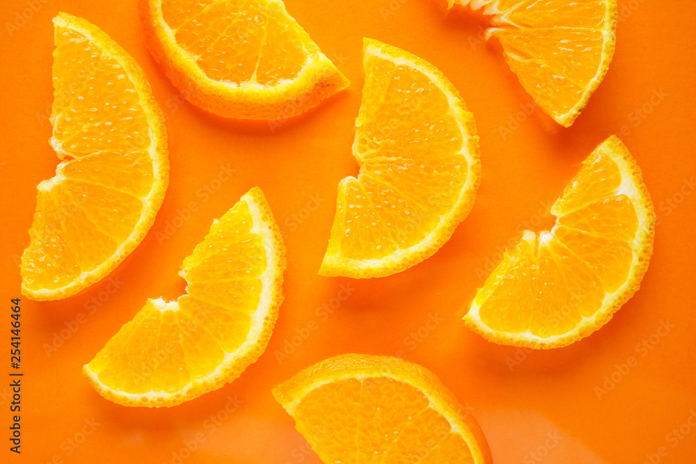 Mandarin slices on an orange background, top view Mandarin slices on an orange background, top view