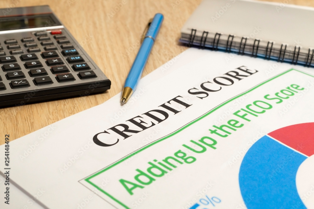 Fototapeta premium Credit score report with calculator on a table.