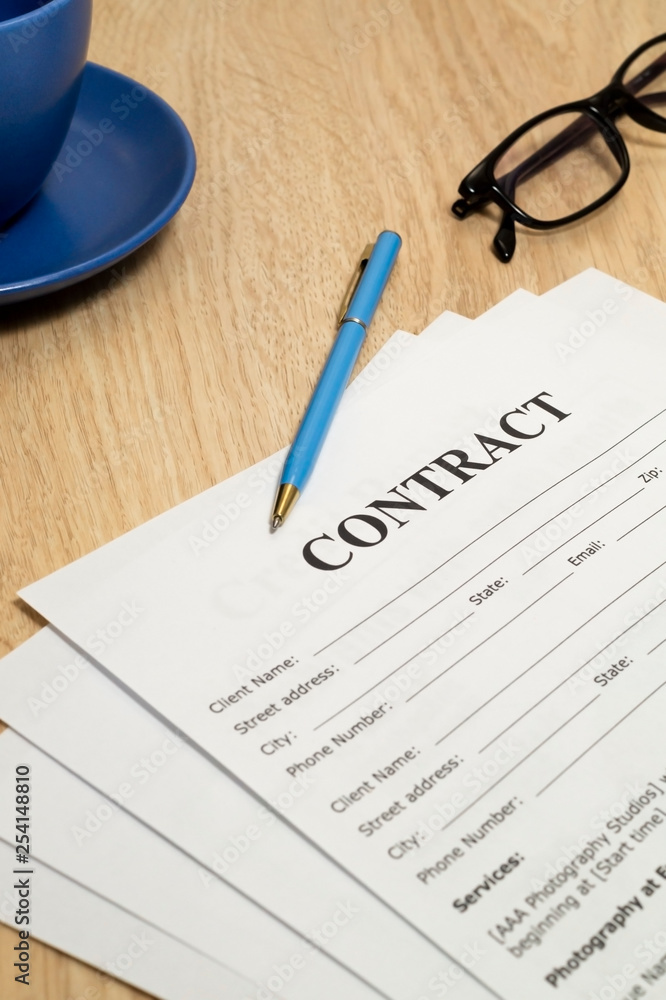 Contract with pen and notebook on wooden table. Contract with pen and notebook on wooden table.