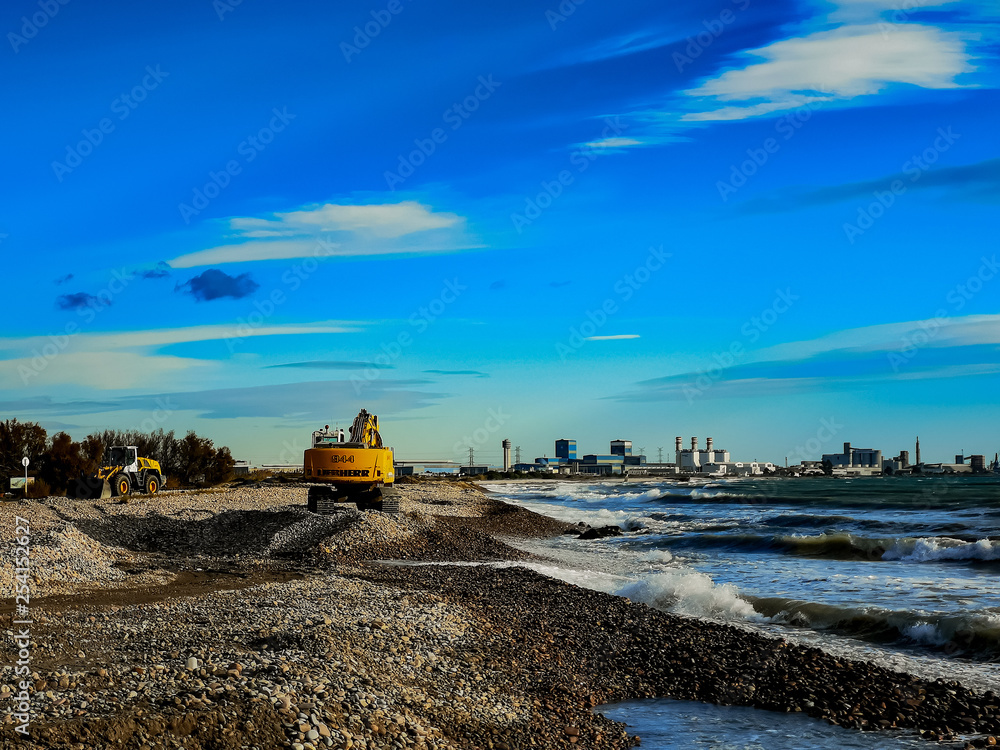 Excavator working on a beach Excavator working on a beach