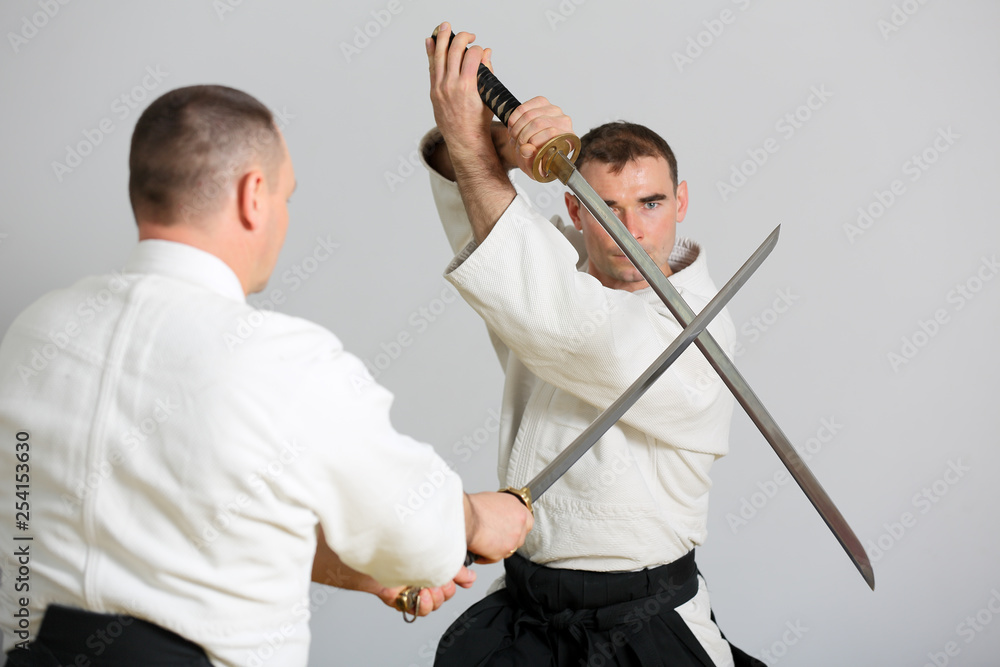 Sword fight. Fighter reflects the attack of the enemy with a samurai sword  . Stock Photo | Adobe Stock