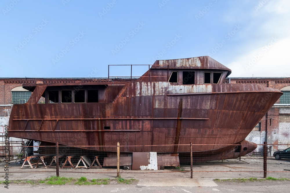 Covered with rust, unfinished ship