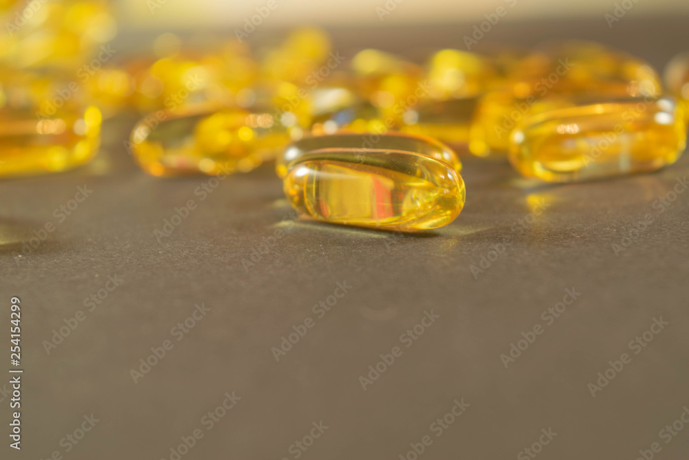 Gelatin capsules with the medicine are scattered across the table.