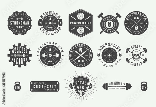 Set of vintage gym fitness logos, emblems, badges, labels, marks and design elements. Retro graphic art. Vector Illustration.