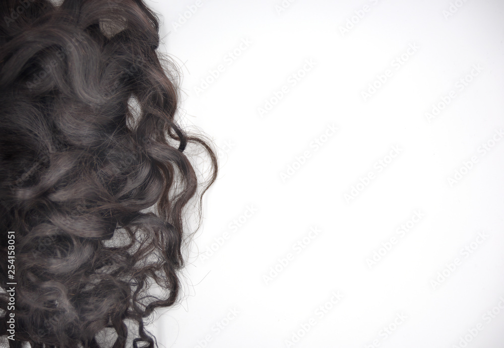 Dark brown curly hair on the white background Dark brown curly hair on the white background