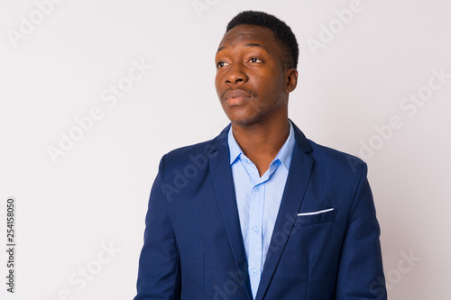 Face of young handsome African businessman thinking