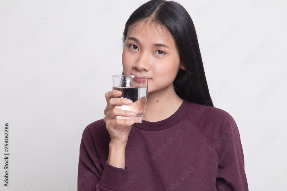 Young Asian woman with a glass of drinking water. Young Asian woman with a glass of drinking water.