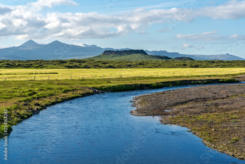 Kalda river flow in western Iceland and Eldborg volcano crater in the center of picture. photo