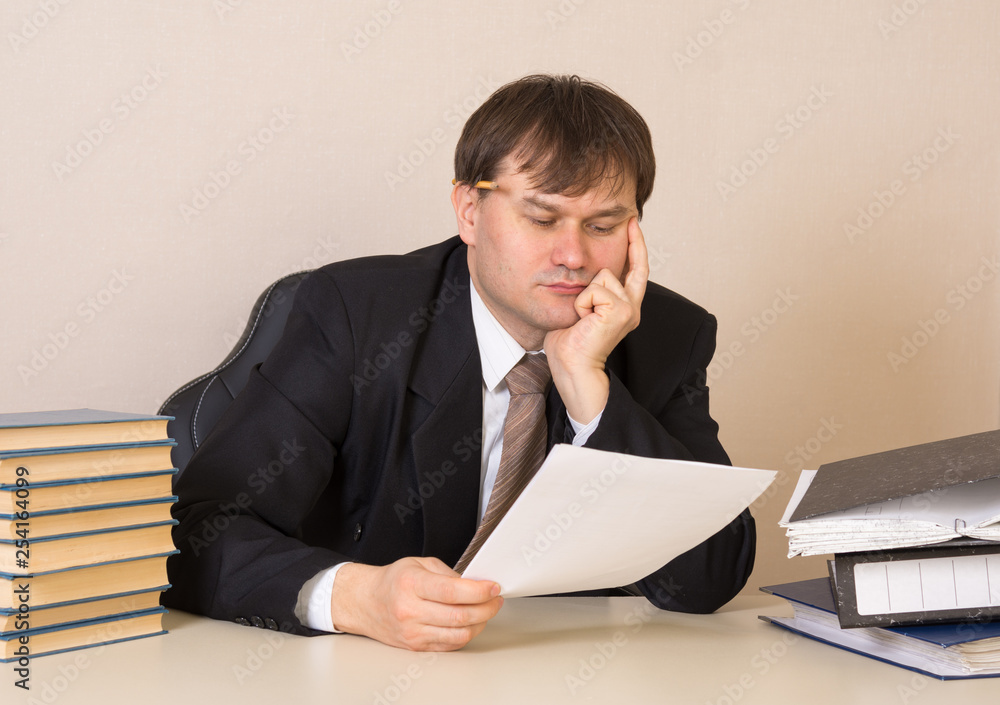 The employee thought about the document at the table in the office The employee thought about the document at the table in the office