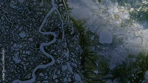 Aerial view of frozen Mackenzie river delta in Canada during sunrise. Contains public domain image by Nasa photo
