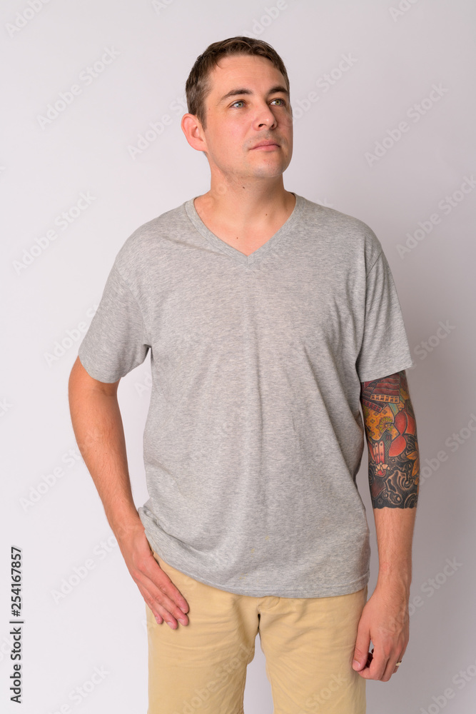 Fototapeta premium Portrait of handsome man with arms tattoos thinking