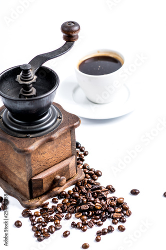 old coffee grinder and cup of coffee