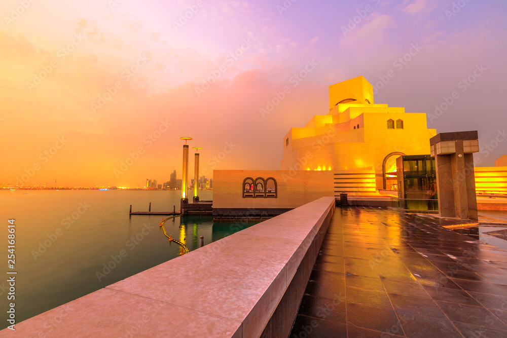 The islamic museum, popular tourist attraction, along Corniche in Qatari capital with Dhow Harbour lighting at blue hour. Doha in Qatar.Middle East, Arabian Peninsula, Persian Gulf. Twilight shot.