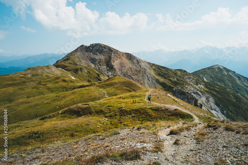 Fototapeta Naklejka Na Ścianę i Meble -   young man hiking in the mountains of Georgia, Caucasus mountain