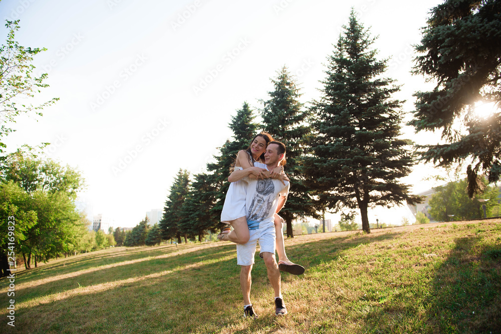 Portrait of the young happy romantic couple who standing in embrace outdoor. Portrait of the young happy romantic couple who standing in embrace outdoor.