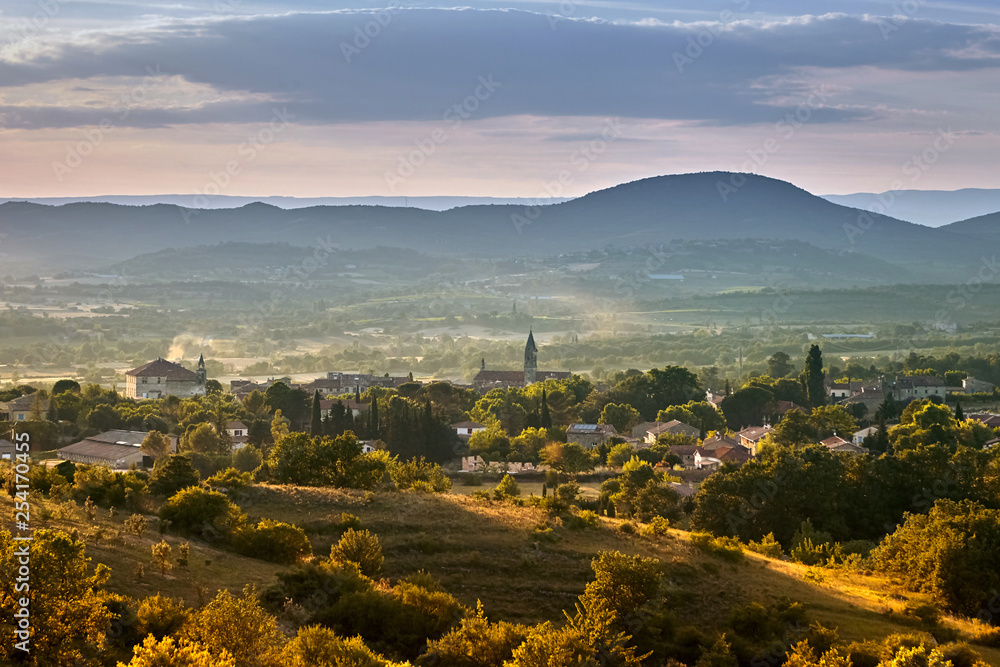 French town of Barjac, hilly mediterranean landscape at sunset, south France, Europe