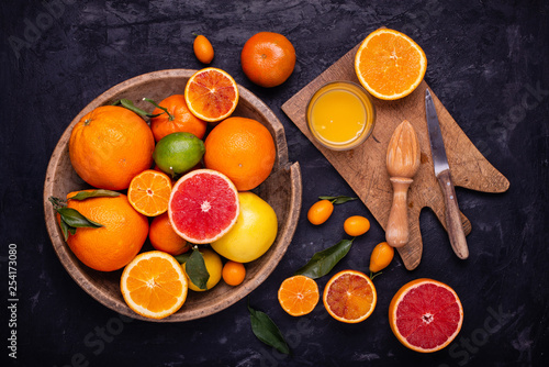 in the rustic wooden plate, sliced citrus and freshly squeezed orange juice photo