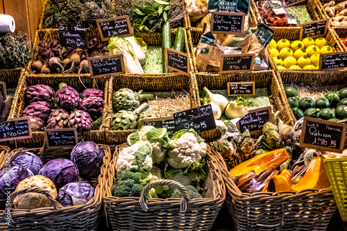 vegetables and fruits at the counter of a covered market