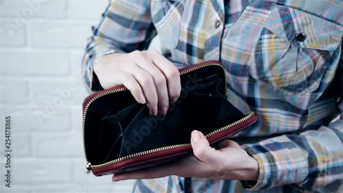 Young caucasian woman with empty wallet - broke