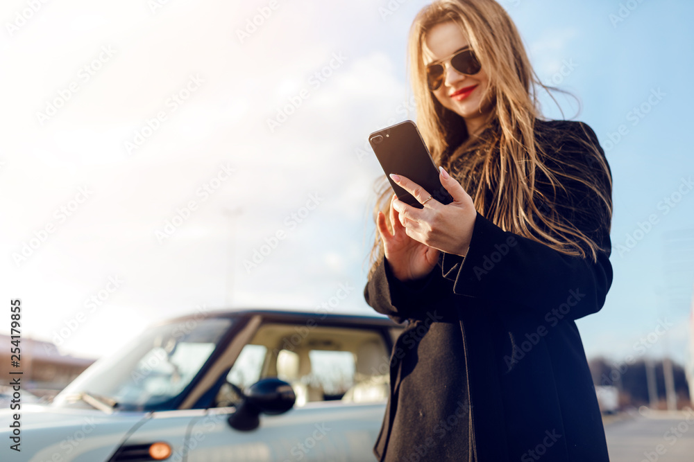 Car. Girl using smartphone. Car. Girl using smartphone.
