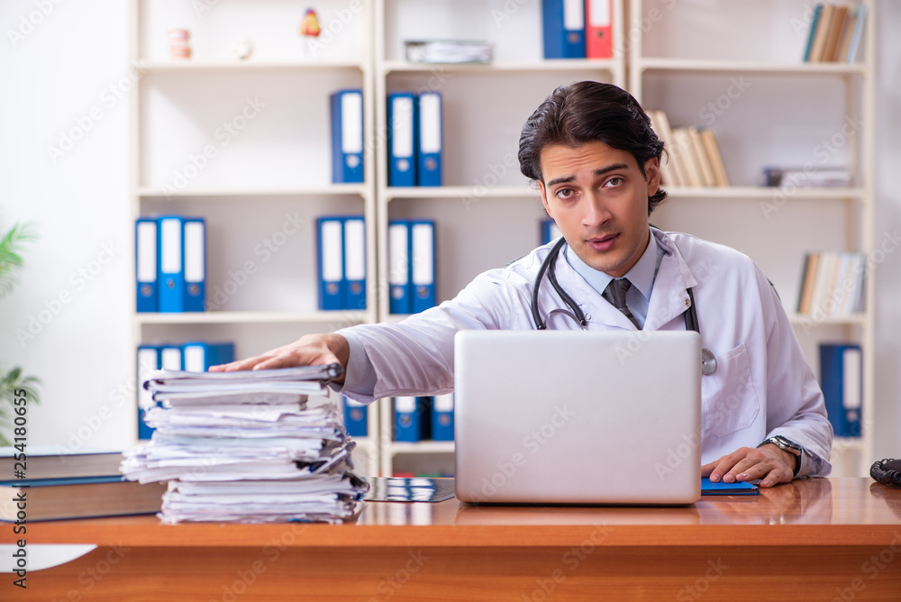 Young handsome doctor working in the clinic Young handsome doctor working in the clinic