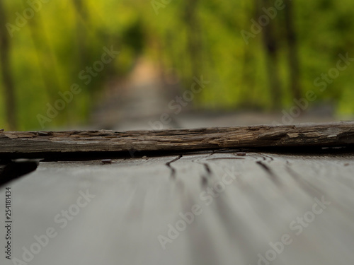 The suspension wooden bridge through the river in the forest. Close up. The long road for courageous and brave through a reservoir at the height of several meters.