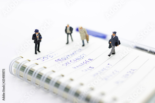 Miniature people: Supervisors look for employees for job placement, using as background Choice of the best suited employee, HR, HRM, HRD, job recruiter concepts.