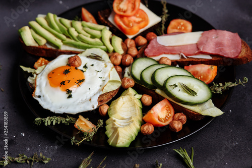 Healthy men's hearty Breakfast on the black table