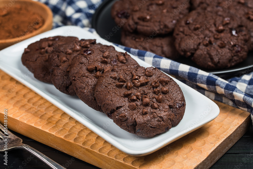 Homemade chocolate cookies on wooden table background. Food baking. Homemade chocolate cookies on wooden table background. Food baking.