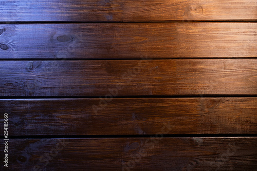 Brown wooden plank texture desk table background with warm and cold lights. Top view, flat lay. Duotone.