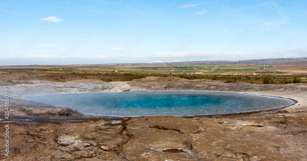 Image of a geyser with beautiful azure water at rest, Iceland