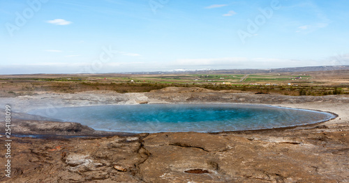 Image of a geyser with beautiful azure water at rest  Iceland