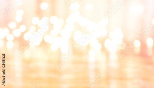Orange festive luminous sparkling lights Christmas or New Year bokeh background with light spots bright sparkling effects texture