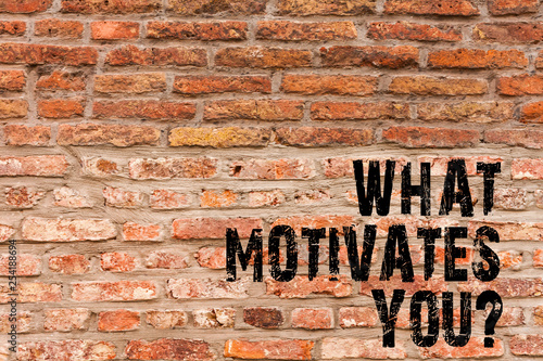 Handwriting text writing What Motivates Youquestion. Conceptual photo Passion Drive Incentive Dream Aspiration Brick Wall art like Graffiti motivational call written on the wall