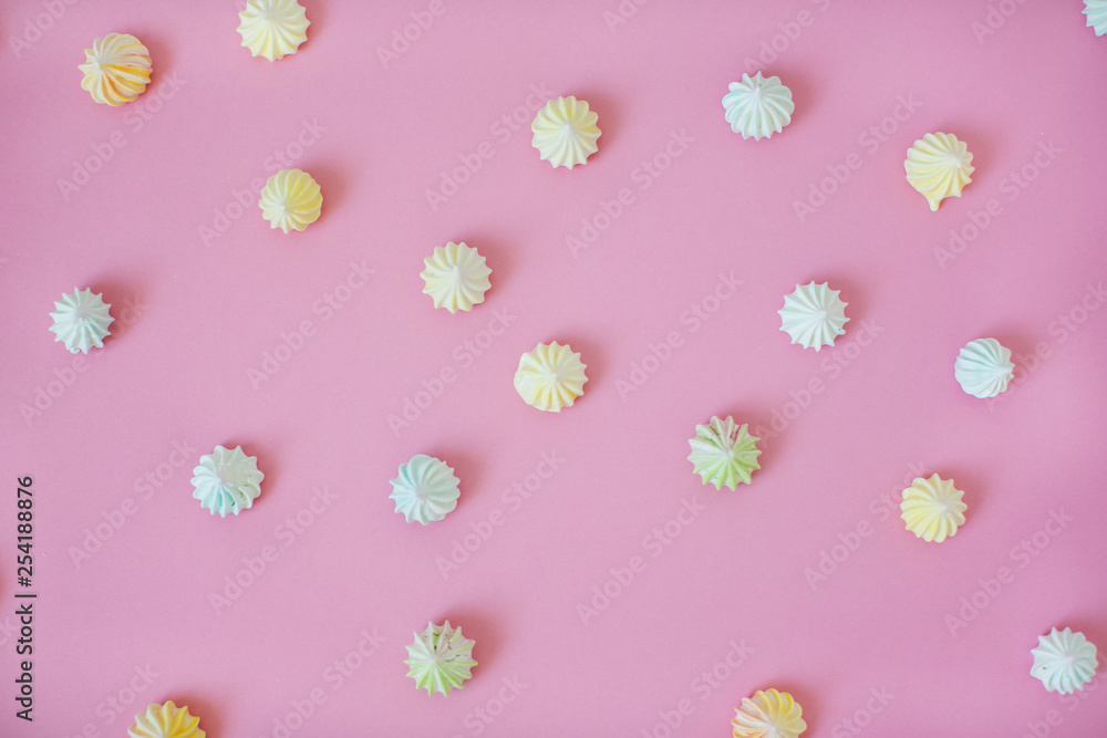 Homemade colorful mini meringues on pink background. Homemade colorful mini meringues on pink background.