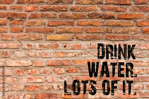 Handwriting text writing Drink Water Lots Of It. Conceptual photo drinking liquids to keep our body in great status Brick Wall art like Graffiti motivational call written on the wall