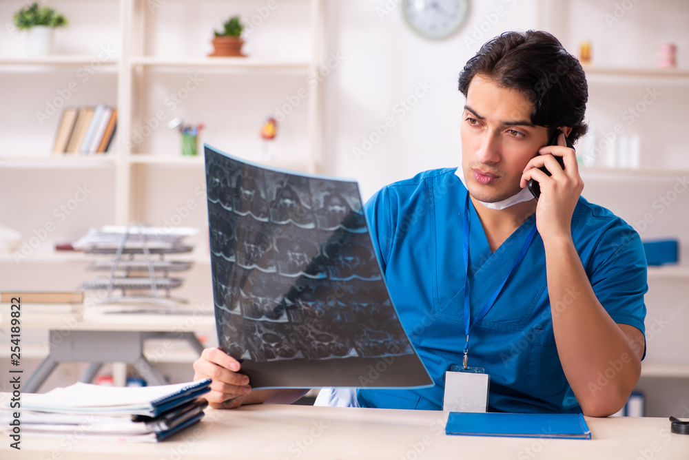 Young handsome doctor radiologist working in the clinic Young handsome doctor radiologist working in the clinic