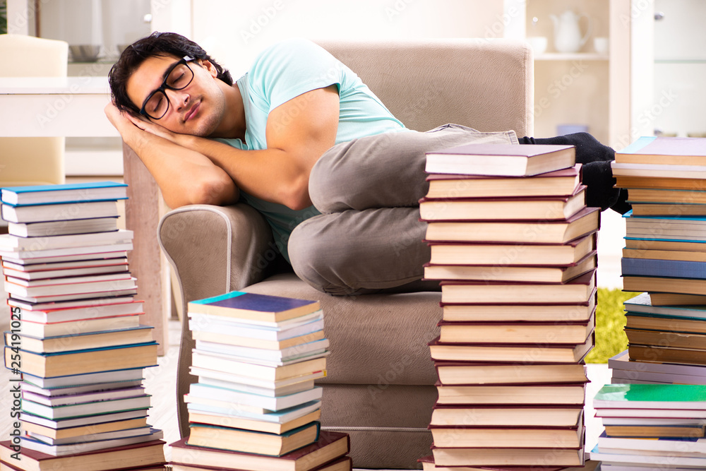 Male student with many books at home Male student with many books at home