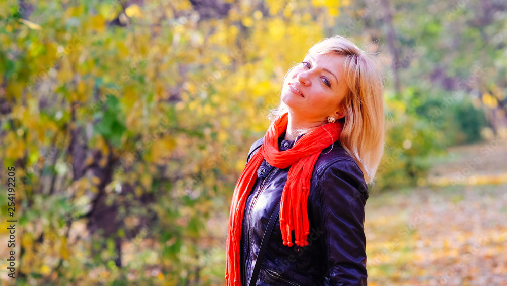 bright beautiful happy blonde woman with blue eyes in black dress on a walk in the Park. bright beautiful happy blonde woman with blue eyes in black dress on a walk in the Park.