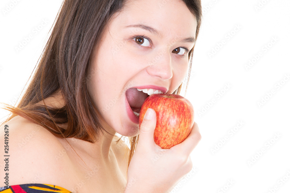 Beautiful young woman eating red apple over white background Beautiful young woman eating red apple over white background