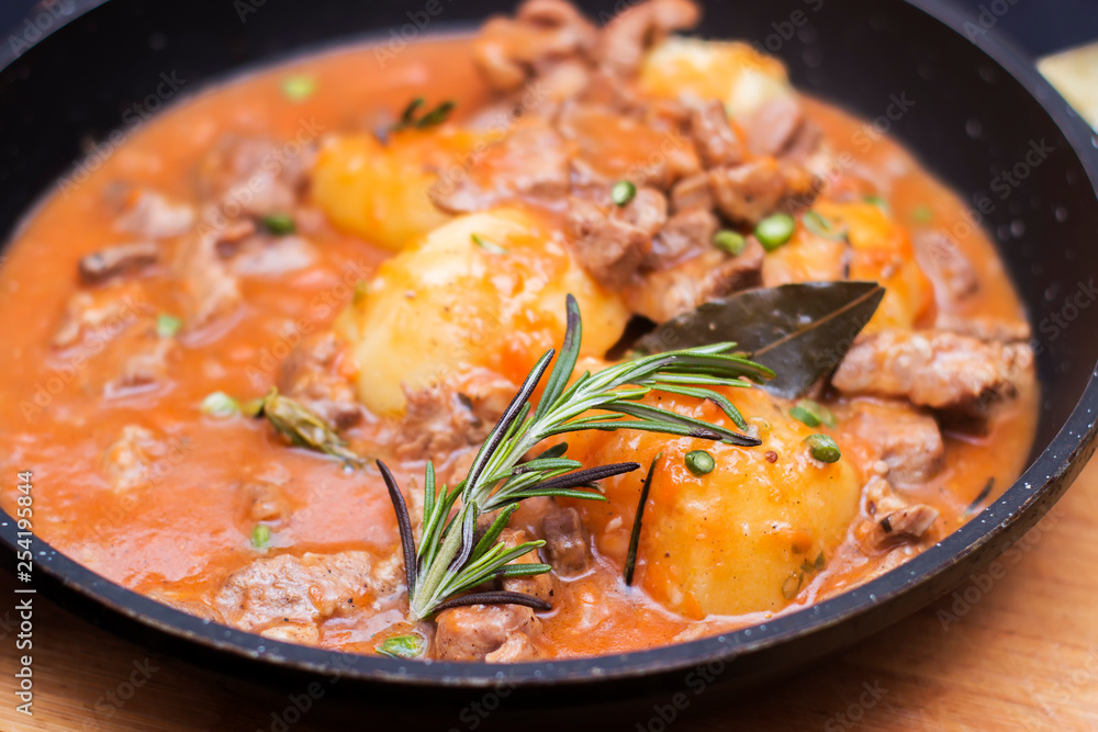 Goulash, beef, pork stew in cast iron pan, top view, close up - Image Goulash, beef, pork stew in cast iron pan, top view, close up - Image