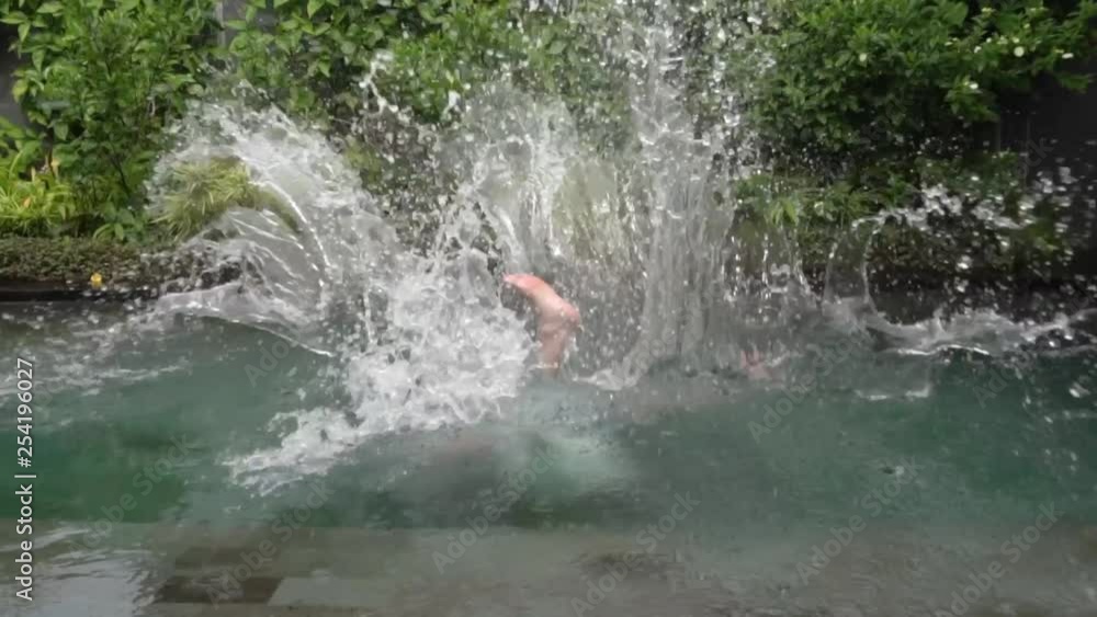 Dressed man fall in the swimming pool. Dressed man fall in the swimming pool.