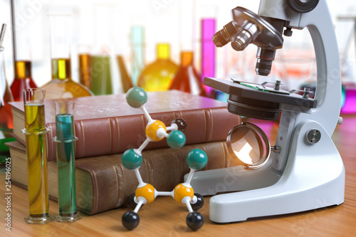 Microscope with alboratory equipmente flasks and vials. Chemistry, biotecnology education concept. photo