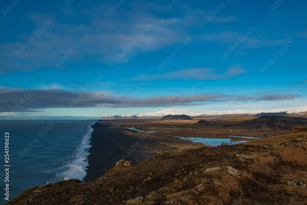 View of the black beach and the mountains from the cliff Dyrholaey. Iceland.