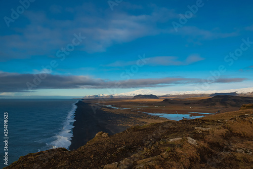 View of the black beach and the mountains from the cliff Dyrholaey. Iceland.