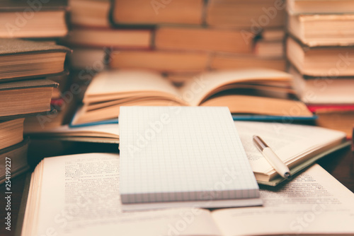 Wallpaper Mural Old open books  and notepad on the table. Piles of of books on reading desk in school study class room, background for education learning concept. Narrow depth of field Torontodigital.ca