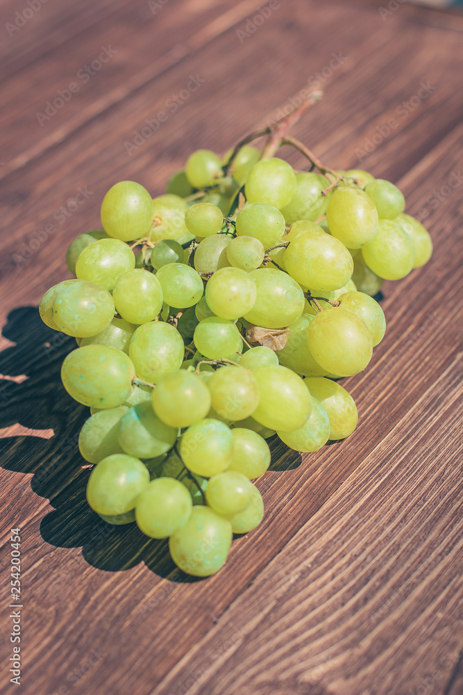 Grapes bunch on a old wooden background. Top view Grapes bunch on a old wooden background. Top view